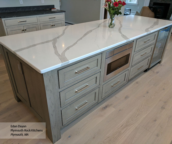 Close-up of island in gray kitchen with inset cabinets